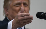 With two bandages on his hand, President Donald Trump gestures while speaking from the Blue Room Balcony of the White House to a crowd of supporters, Saturday, Oct. 10, 2020, in Washington. (AP/Alex Brandon)