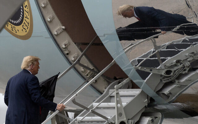 US President Donald Trump boards Air Force One, Monday, Oct. 12, 2020, at Andrews Air Force Base, Md. Trump is en route to Florida. (AP Photo/Alex Brandon) US President Donald Trump boards Air Force One, Monday, Oct. 12, 2020, at Andrews Air Force Base, Md. Trump is en route to Florida. (AP Photo/Alex Brandon)