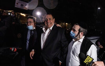 Heshy Tischler, center, then a City Council candidate and activist in the Orthodox Jewish neighborhood of Borough Park, walks out of Kings County Criminal Court after an arraignment, October 12, 2020, in New York. (AP Photo/Yuki Iwamura)