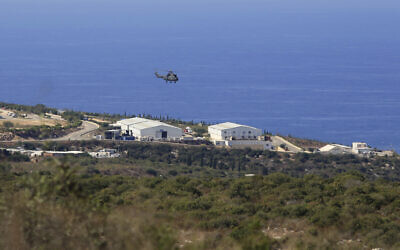 A helicopter flies over a base of the UN peacekeeping force, in the town of Naqoura, Lebanon, October 14, 2020, during the first round of talks between Lebanese and Israeli delegations on the countries' maritime border. (AP/Bilal Hussein)