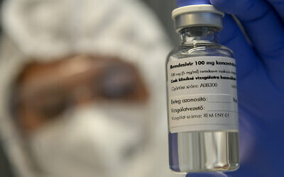 A bottle containing the drug Remdesivir is shown by a health worker at the Institute of Infectology of Kenezy Gyula Teaching Hospital of the University of Debrecen in Debrecen, Hungary, October 15, 2020. (Zsolt Czegledi/MTI via AP)