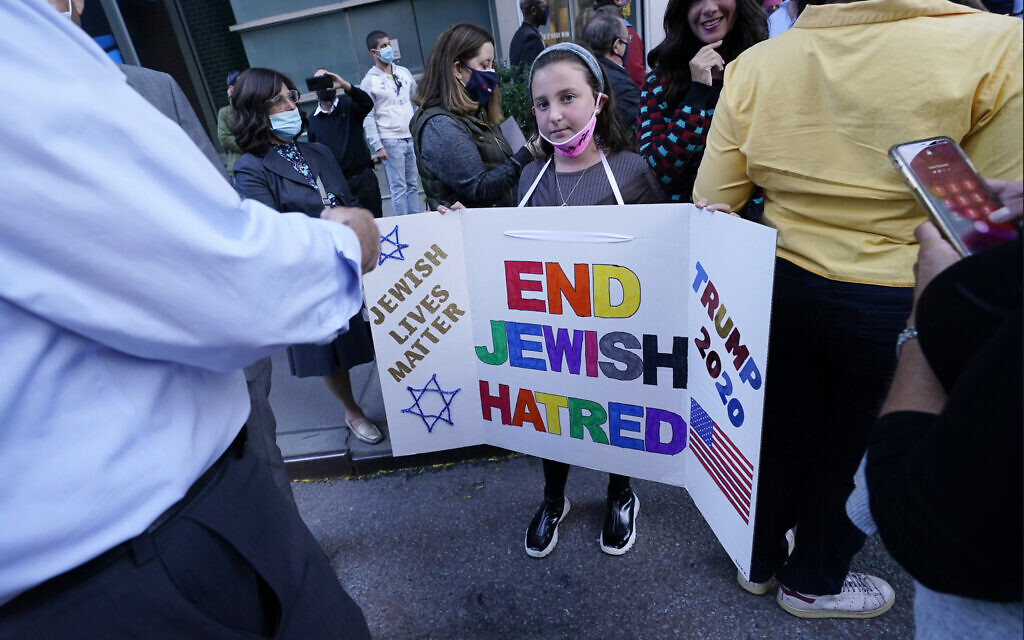 A young girl holds a poster she made as she joined protesters outside the offices of New York Gov. Andrew Cuomo, Thursday, Oct. 15, 2020, in New York. (AP Photo/Kathy Willens) A young girl holds a poster she made as she joined protesters outside the offices of New York Gov. Andrew Cuomo, Thursday, Oct. 15, 2020, in New York. (AP Photo/Kathy Willens)