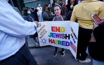 A young girl holds a poster she made as she joined protesters outside the offices of New York Gov. Andrew Cuomo, Thursday, Oct. 15, 2020, in New York. (AP Photo/Kathy Willens) A young girl holds a poster she made as she joined protesters outside the offices of New York Gov. Andrew Cuomo, Thursday, Oct. 15, 2020, in New York. (AP Photo/Kathy Willens)