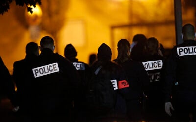 French police officers gather outside a high school after a history teacher who opened a discussion with students on caricatures of Islam's Prophet Muhammad was beheaded in Conflans-Saint-Honorine, north of Paris, October 16, 2020. (AP Photo/Michel Euler)
