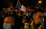 People attend a memorial march in homage to the history teacher who was beheaded last week, Tuesday, Oct.20, 2020 in Conflans-Sainte-Honorine, northwest of Paris. Samuel Paty was beheaded on Friday by an 18-year-old Moscow-born Chechen refugee, who was later shot dead by police. Police officials said Paty had discussed caricatures of Islam's Prophet Muhammad with his class, leading to threats. (AP Photo/Lewis Joly)
