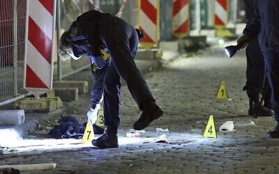 Criminal experts investigate a crime scene in Dresden, Germany, on October 5, 2020,  after two people were killed in a knife attack. (Roland Halkasch/dpa via AP, file)