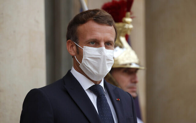 French President Emmanuel Macron, left, wearing a protective face mask, waits to welcome Armenian President Armen Sarkissian for a meeting at the Elysee Palace in Paris, Thursday, Oct. 22, 2020. (Charles Platiau/Pool via AP) French President Emmanuel Macron, left, wearing a protective face mask, waits to welcome Armenian President Armen Sarkissian for a meeting at the Elysee Palace in Paris, Thursday, Oct. 22, 2020. (Charles Platiau/Pool via AP)