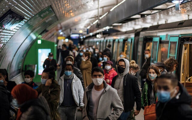 Commuters wearing face masks walk on the platform, of a Paris subway, Oct.25, 2020 (AP Photo/Lewis Joly) Commuters wearing face masks walk on the platform, of a Paris subway, Oct.25, 2020 (AP Photo/Lewis Joly)