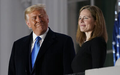 US President Donald Trump and Amy Coney Barrett stand on the Blue Room Balcony after Supreme Court Justice Clarence Thomas administered the Constitutional Oath to her on the South Lawn of the White House White House in Washington, Oct. 26, 2020 (AP Photo/Patrick Semansky)