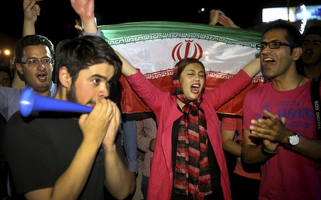 In this July 14, 2015, photo, an Iranian woman holds up a national flag as people celebrate a landmark nuclear deal, in Tehran, Iran. (AP Photo/Ebrahim Noroozi) In this July 14, 2015, photo, an Iranian woman holds up a national flag as people celebrate a landmark nuclear deal, in Tehran, Iran. (AP Photo/Ebrahim Noroozi)