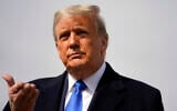 US President Donald Trump talks to reporters before boarding Air Force One for a day of campaign rallies in Michigan, Wisconsin, and Nebraska, at Andrews Air Force Base, Maryland, October 27, 2020. (Evan Vucci/AP)