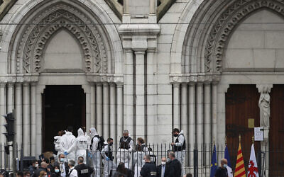 French police and forensic officers work on the scene of the knife attack in front of Notre Dame church, in Nice, France, Oct. 29, 2020 (AP Photo/Daniel Cole)