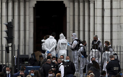 French policemen and forensic officers work on the scene of the knife attack in front of Notre Dame church, in Nice, France, October 29, 2020. An attacker armed with a knife killed three people at a church in the Mediterranean city of Nice, the third attack in two months in France. (AP Photo/Daniel Cole)