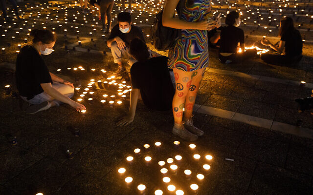 Israelis light memorial candles on the 25th anniversary of the assassination of Prime Minister Yitzhak Rabin, at Rabin Square, Tel Aviv, Israel, Thursday, Oct. 29, 2020. (AP Photo/Oded Balilty)