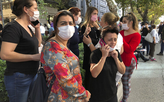 People stand outside their homes in Izmir, Turkey, Oct. 30, 2020, after a strong earthquake in the Aegean Sea has shaken Turkey and Greece (AP Photo/Ismail Gokmen)
