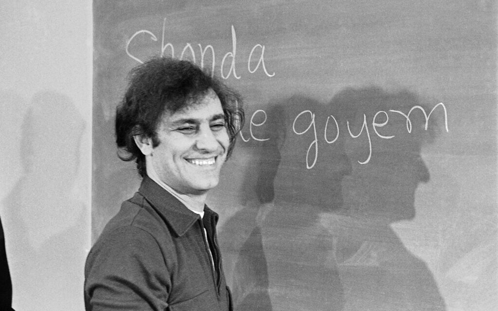 Abbie Hoffman smiles at the blackboard during a news conference, February 5, 1970 in Chicago. He's among the Chicago 7 on trial for conspiracy to cause riots at the time of the Democratic National Convention. (AP Photo/Jim Palmer)
