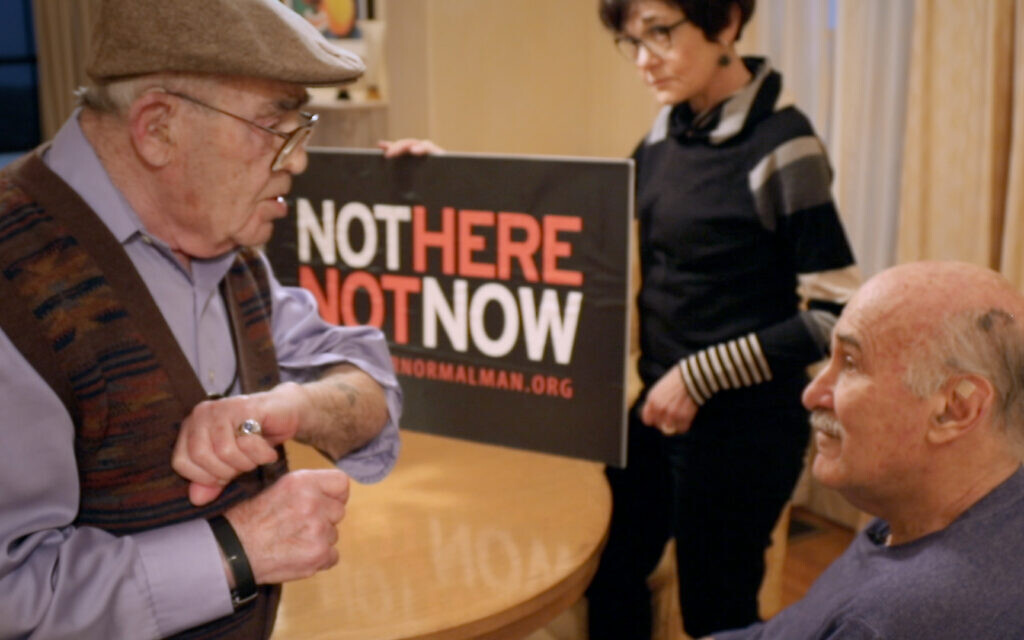 Holocaust survivor Ben Stern, left, shows Ira Glasser his concentration camp tattoo in this still from 'Mighty Ira.' (Courtesy)