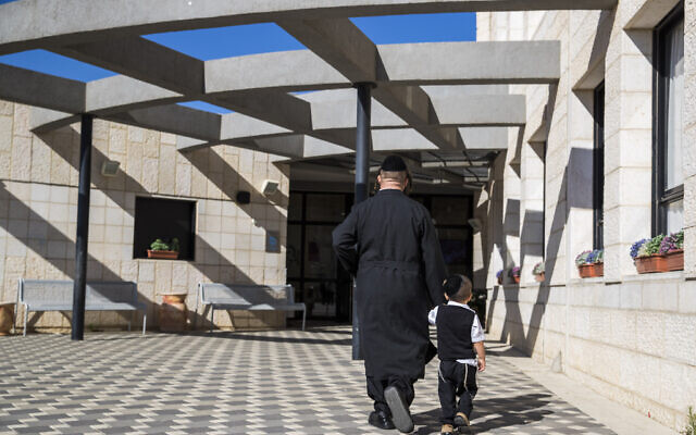 Illustrative: An ultra-Orthodox man walks his son to the Poalei Menahem Talmud Torah school, in the West Bank settlement of Beitar Illit, September 4, 2016. (Nati Shohat/Flash90) Illustrative: An ultra-Orthodox man walks his son to the Poalei Menahem Talmud Torah school, in the West Bank settlement of Beitar Illit, September 4, 2016. (Nati Shohat/Flash90)