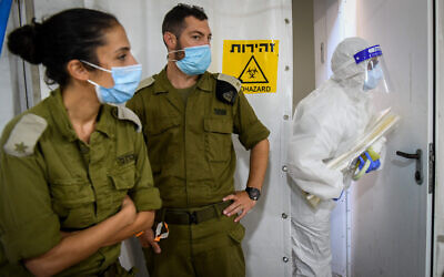 Illustrative. Israeli army technicians carry out a diagnostic test for coronavirus in a military lab in central Israel on July 15, 2020. (Yossi Zeliger/Flash90)