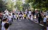 First grade students arrive for their first day of school at Tali Geulim school in Jerusalem on September 1, 2020. (Noam Revkin Fenton/Flash90)