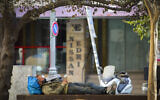 A man sleeps on a public bench next to closed shops on Hillel Street in downtown Jerusalem, on September 23, 2020, during a nationwide lockdown. (Nati Shohat/Flash90)