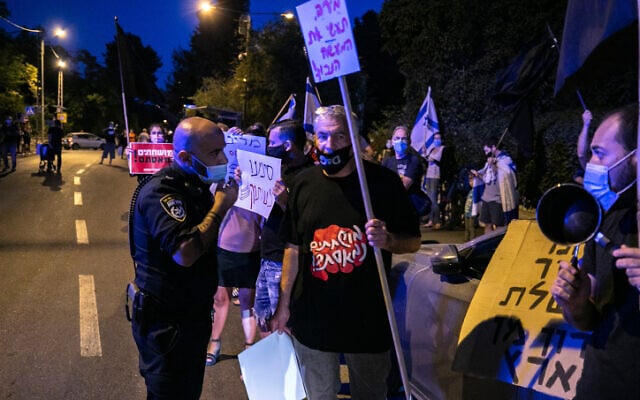 People protest against Prime Minister Benjamin Netanyahu outside Likud MK Nir Barkat's house at the Beit HaKerem neighborhood in Jerusalem on October 3, 2020 (Olivier Fitoussi/Flash90) People protest against Prime Minister Benjamin Netanyahu outside Likud MK Nir Barkat's house at the Beit HaKerem neighborhood in Jerusalem on October 3, 2020 (Olivier Fitoussi/Flash90)