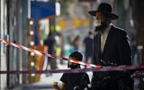 People wearing face masks walk in downtown Jerusalem on October 15, 2020, during a nationwide lockdown. ( Olivier Fitoussi/Flash90)