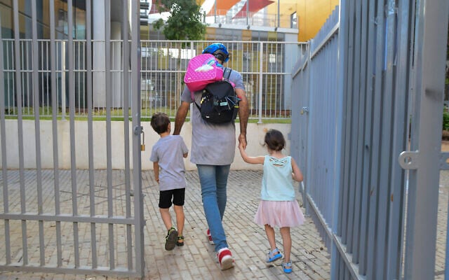 Parents accompany their children to kindergarten in Tel Aviv, on October 18, 2020. (Avshalom Sassoni/Flash90) Parents accompany their children to kindergarten in Tel Aviv, on October 18, 2020. (Avshalom Sassoni/Flash90)