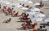 Israelis on the beach in Tel Aviv on October 18, 2020, as lockdown restrictions were eased. (Miriam Alster/FLASH90)