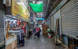 People walk in the almost empty market in Rehovot, on October 19, 2020 (Yossi Aloni/Flash90)