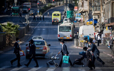 Illustrative: Ultra-Orthodox Jews walk in Jerusalem on October 19, 2020. (Yonatan Sindel/Flash90)