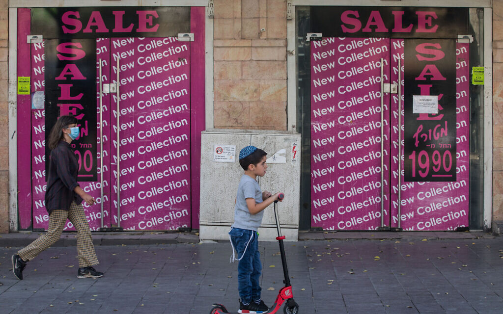A child plays in the city center of Jerusalem as Israel steps out of coronavirus lockdown and rolls back restrictions on October 21, 2020. (Nati Shohat/Flash90) A child plays in the city center of Jerusalem as Israel steps out of coronavirus lockdown and rolls back restrictions on October 21, 2020. (Nati Shohat/Flash90)