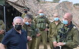 Prime Minister Benjamin Netanyahu (L) visits a military drill in northern Israel on October 28, 2020. (Amos Ben Gershom/GPO)