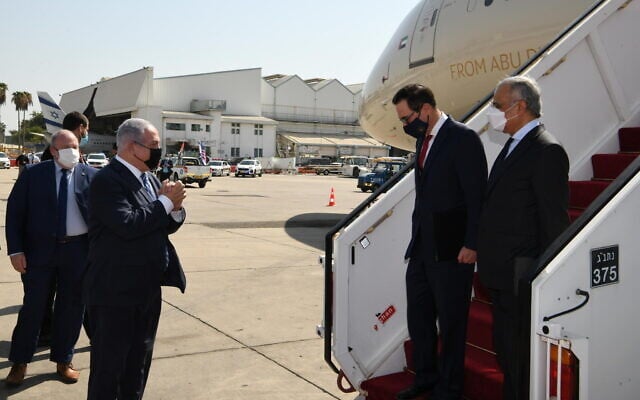PM Netanyahu, left, greets US Secretary of the Treasury Steven Mnuchin and UAE Minister of State for Financial Affairs Obaid Humaid Al Tayer ahead of a ceremony during which Israel and the UAE signed four bilateral agreements at Tel Aviv's Ben Gurion Airport, October 20, 2020 (Amos Ben Gershom/GPO) PM Netanyahu, left, greets US Secretary of the Treasury Steven Mnuchin and UAE Minister of State for Financial Affairs Obaid Humaid Al Tayer ahead of a ceremony during which Israel and the UAE signed four bilateral agreements at Tel Aviv's Ben Gurion Airport, October 20, 2020 (Amos Ben Gershom/GPO)