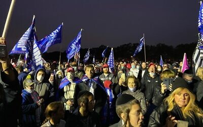 People gather near the stage of a pro-Trump rally at Marine Park in Brooklyn, New York on October 25, 2020. (Jacob Magid/Times of Israel)