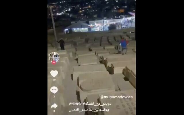 A video uploaded to TikTok shows two people running on graves at the Mount of Olives cemetery in Jerusalem. (Screen capture: Twitter) A video uploaded to TikTok shows two people running on graves at the Mount of Olives cemetery in Jerusalem. (Screen capture: Twitter)