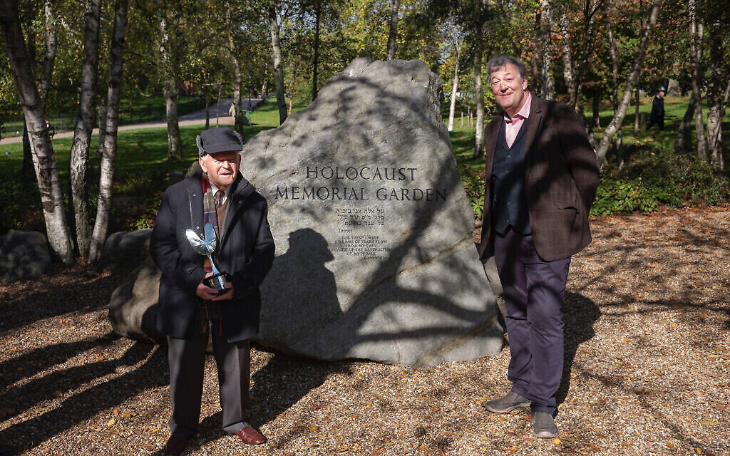 Holocaust survivor and double Olympian Sir Ben Helfgott receives his Pride of Britain award from Stephen Fry by the Holocaust Memorial in Hyde Park, London, October 2020. (Philip Coburn/ via Jewish news) Holocaust survivor and double Olympian Sir Ben Helfgott receives his Pride of Britain award from Stephen Fry by the Holocaust Memorial in Hyde Park, London, October 2020. (Philip Coburn/ via Jewish news)