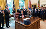 US President Donald Trump reacts after hanging up a phone call with the leaders of Sudan and Israel announcing normalization between the two countries, Oct. 23, 2020, in Washington. (AP Photo/Alex Brandon)