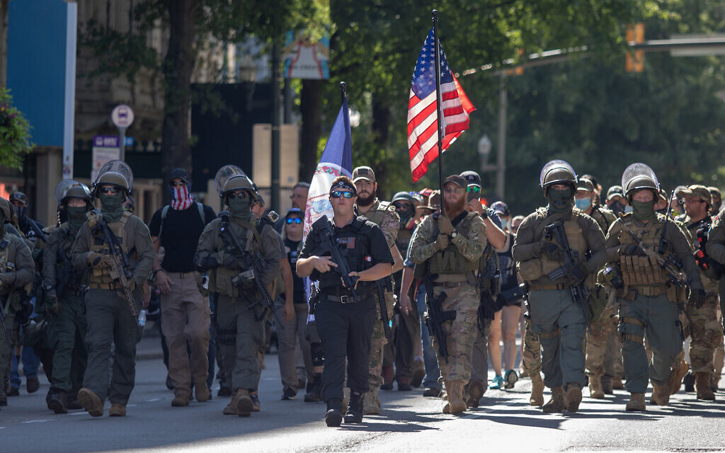 Illustrative: Armed gun rights protesters, led by a member of the far-right Boogaloo boys, march in Richmond, Virginia, August 18, 2020. (Chad Martin/LightRocket via Getty Images, JTA) Illustrative: Armed gun rights protesters, led by a member of the far-right Boogaloo boys, march in Richmond, Virginia, August 18, 2020. (Chad Martin/LightRocket via Getty Images, JTA)