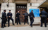 Illustrative: New York police officers stand guard at the door of the Union Temple of Brooklyn, November 2, 2018. (Kena Betancur/AFP/Getty Images via JTA)