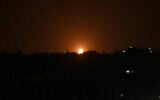 Illustrative: Flames are seen following an Israeli air strike in the town of Deir al-Balah in the central Gaza Strip, October 20, 2020. (Said Khatib/AFP)