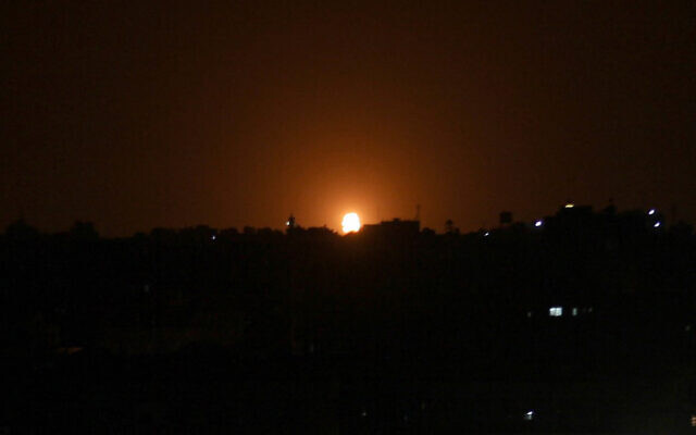 Illustrative: Flames are seen following an Israeli air strike in the town of Deir al-Balah in the central Gaza Strip, October 20, 2020. (Said Khatib/AFP) Illustrative: Flames are seen following an Israeli air strike in the town of Deir al-Balah in the central Gaza Strip, October 20, 2020. (Said Khatib/AFP)