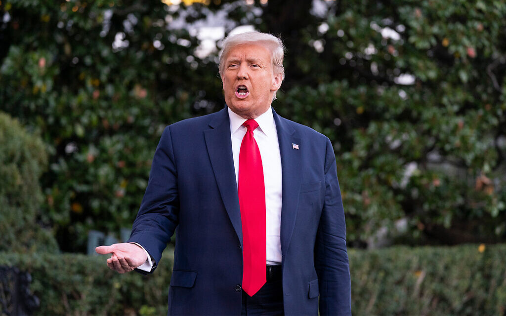 US President Donald Trump speaks with reporters as he walks to Marine One on the South Lawn of the White House in Washington, October 13, 2020. (AP Photo/Alex Brandon)