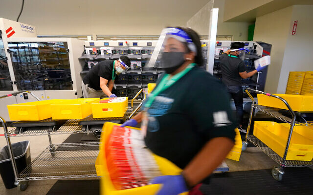 Election workers sort returned ballots at the King County Elections office in Renton, Washington, Oct. 20, 2020. (AP Photo/Elaine Thompson) Election workers sort returned ballots at the King County Elections office in Renton, Washington, Oct. 20, 2020. (AP Photo/Elaine Thompson)