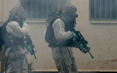 IDF soldiers in chemical protection suits hold an exercise simulating a chemical attack as part of a nationwide civil defense exercise in Ramat Gan, near Tel Aviv, on March 20, 2007. (Roni Schutzer/Flash90) IDF soldiers in chemical protection suits hold an exercise simulating a chemical attack as part of a nationwide civil defense exercise in Ramat Gan, near Tel Aviv, on March 20, 2007. (Roni Schutzer/Flash90)