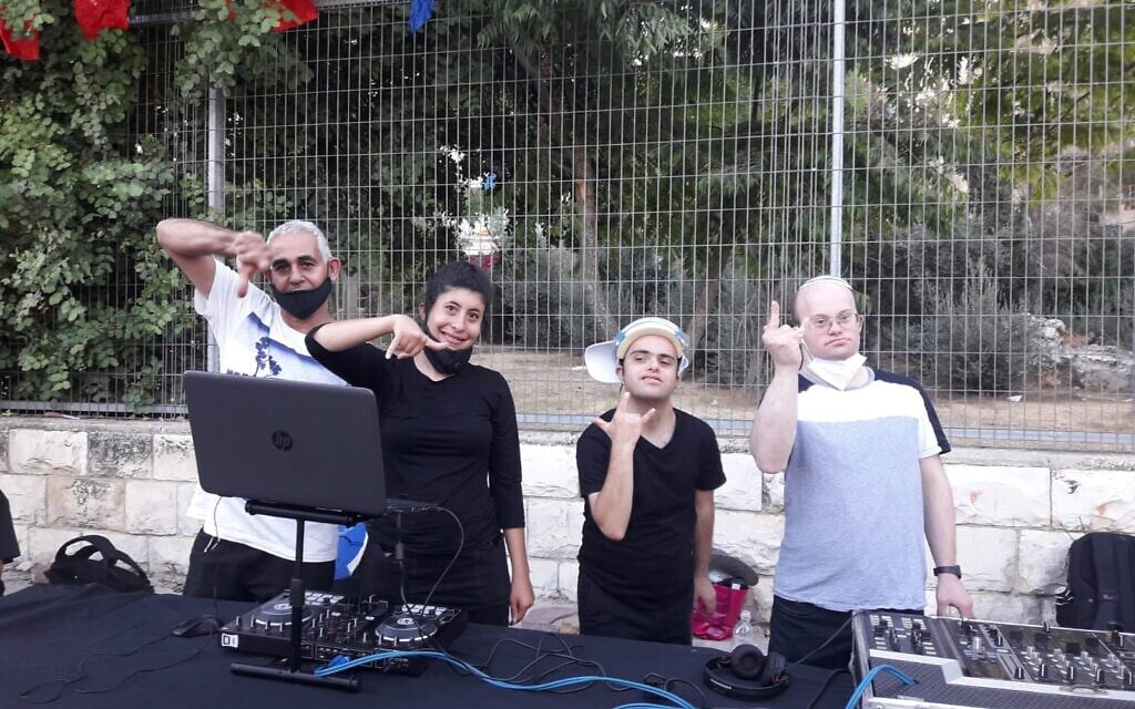Noam Yomtovyan (second from right) and some of his fellow Special DJs performing for assisted living facilities and coronavirus hotels in Jerusalem on October 7, 2020 (Courtesy Tzamid)