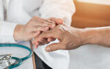 Illustrative image of a doctor comforting a patient with Alzheimer's Disease. (Chinnapong, iStock by Getty Images)