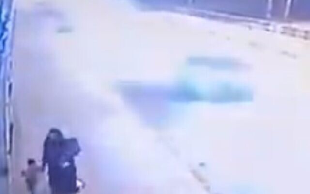 CCTV footage shows a mother in Iraq leading her two small children along a bridge before she throws them in the river (Screencapture) CCTV footage shows a mother in Iraq leading her two small children along a bridge before she throws them in the river (Screencapture)
