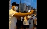 A right-wing protesters sprays mace at anti-Netanyahu demonstrators. October 13, 2020 (screen capture via Twitter)