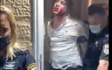 Police lead away the brother of the bride after breaking up a wedding that violated coronavirus restrictions in Givat Ze'ev on October 14, 2020 (screencapture/Twitter)